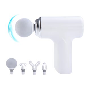 White handheld facial cleansing device with a round soft brush head attached, and several interchangeable heads laid out beside it.