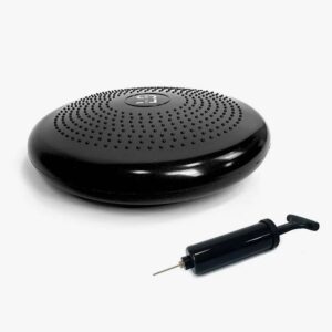 Round black device with a perforated top and a small hand pump lying nearby; resembles a compact speaker or massage pad with a needle-like nozzle accessory nearby.