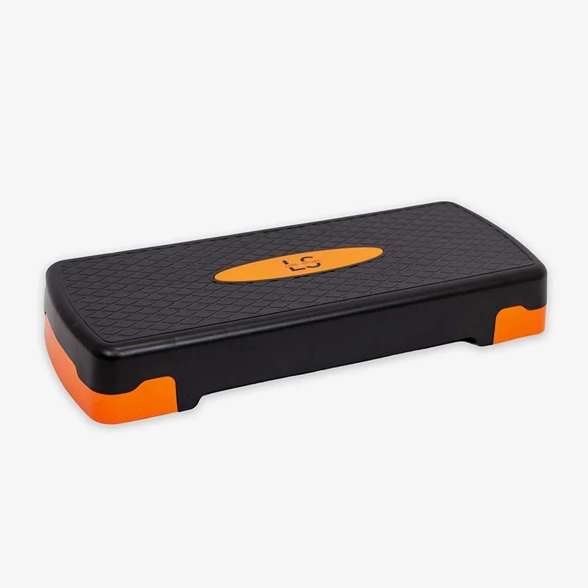 steper_za_aerobiko_10 - fizio trgovina compact black aerobic step platform with orange ends and textured surface for grip and stability on workouts.