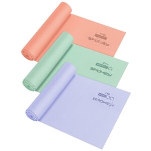 Three rolled yoga mats in peach, mint green, and lavender, each labeled with weight and the Spokey brand.