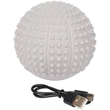 White textured massage ball with raised nodules and a USB charging cable beside it.