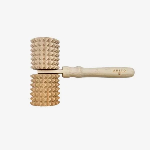 masazni_valjcek_11 - fizio trgovina leatherworking hammer with two knurled wooden heads on a light wood handle labeled akito.